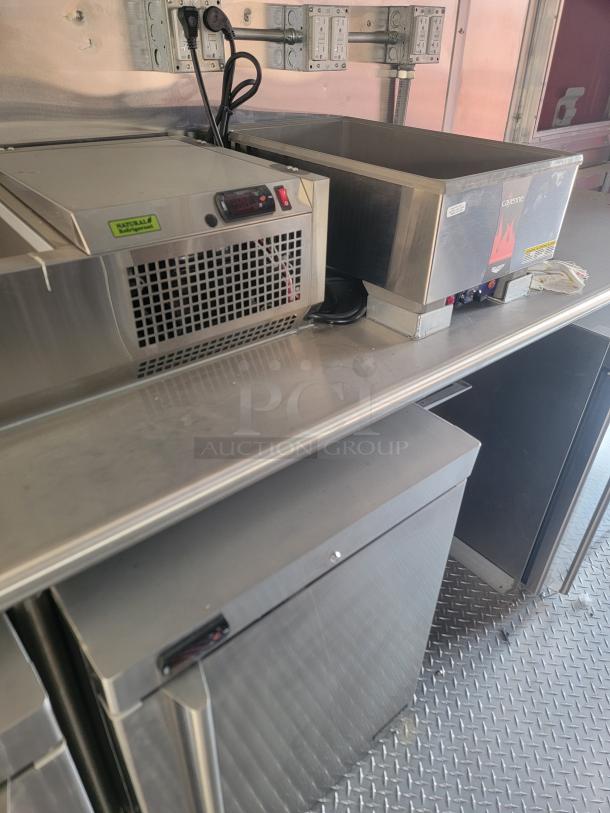 Commercial kitchen equipment including a Cayenne warmer and refrigeration unit on a stainless steel counter, good condition.