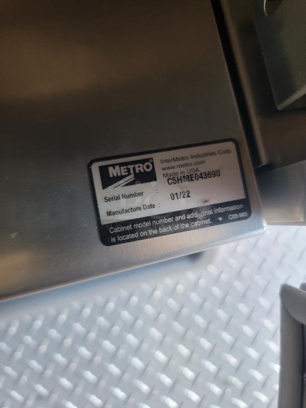 Metal cabinet with Metro label. Model C5HME043690, manufactured 01/22, made in USA. Serial number visible.