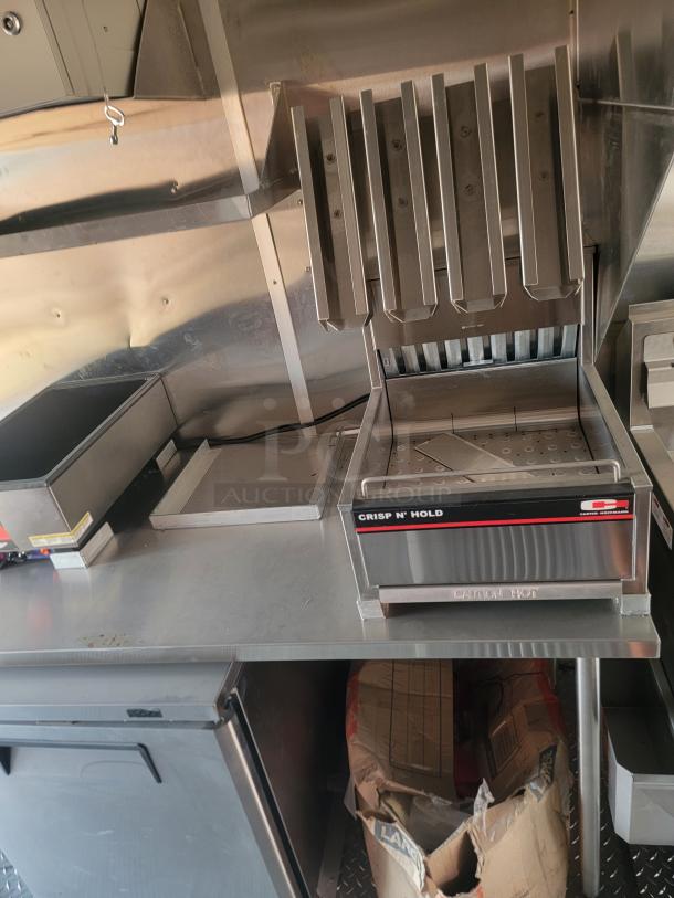 Carter Hoffmann Crisp 'N Hold food warmer, stainless steel, six-slot design, excellent condition, labeled "Caution Hot."
