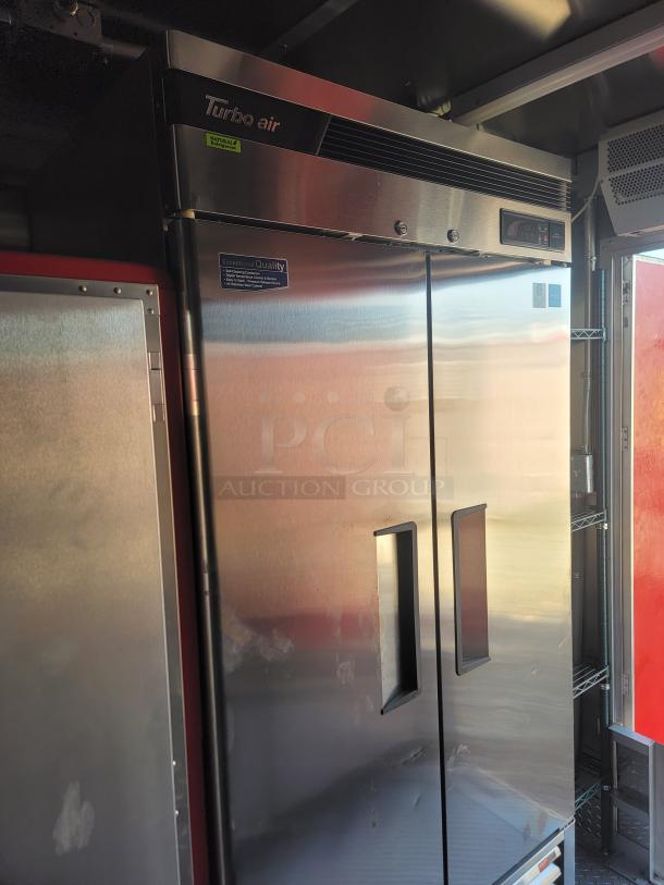 Turbo Air stainless steel two-door commercial refrigerator with digital controls. Features quality assurance sticker.