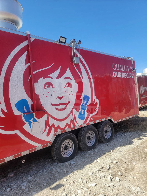 2021 Rock Solid Cargo 8.5' x 28' triple-axle mobile kitchen trailer with CaptiveAire hood, visible brand logo, and corporate design.