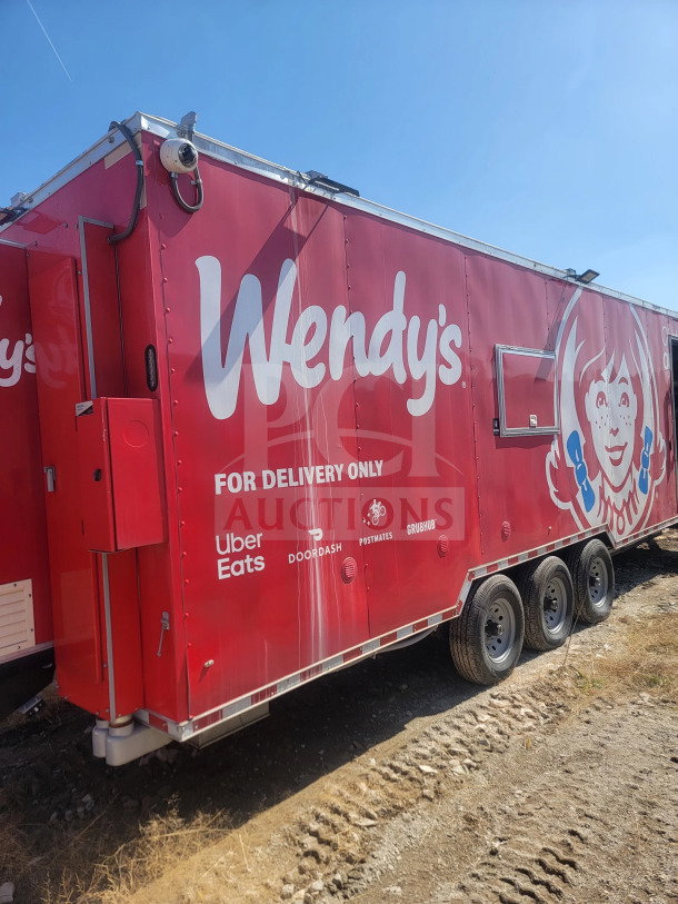 2021 Rock Solid Cargo 8.5' x 28' triple-axle mobile kitchen trailer with corporate delivery branding, red exterior.