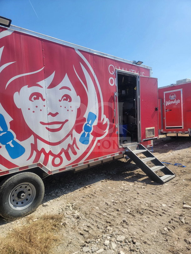 2021 Rock Solid Cargo 8.5' x 28' mobile kitchen trailer, CaptiveAire hood, triple-axle, vibrant red with graphics, side steps.