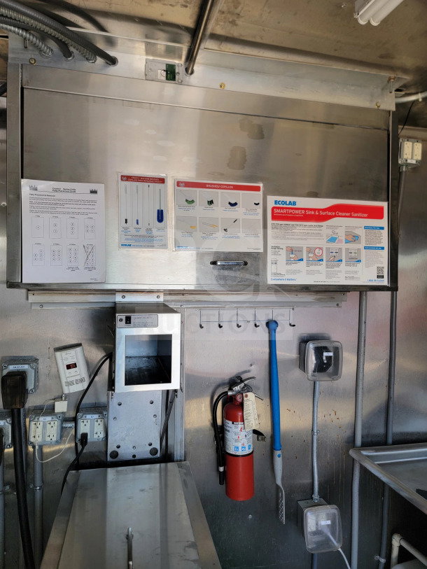 2021 Rock Solid Cargo trailer interior, showing kitchen suite, CaptiveAire hood, fire extinguisher, and sanitation guidelines.