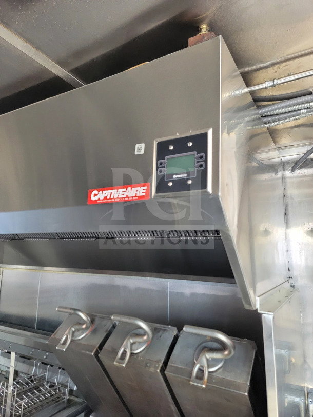 CaptiveAire hood system inside a Rock Solid Cargo mobile kitchen trailer, features stainless steel design with control panel.