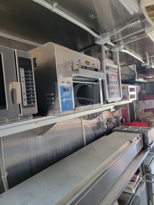 2021 Rock Solid Cargo 8.5' x 28' mobile kitchen trailer interior with full kitchen suite, appliances, and CaptiveAire hood.