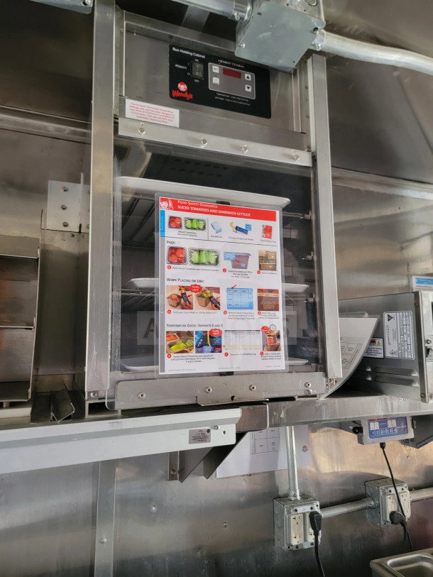 Interior of a 2021 Rock Solid Cargo 8.5' x 28' mobile kitchen trailer with CaptiveAire hood and full kitchen suite.