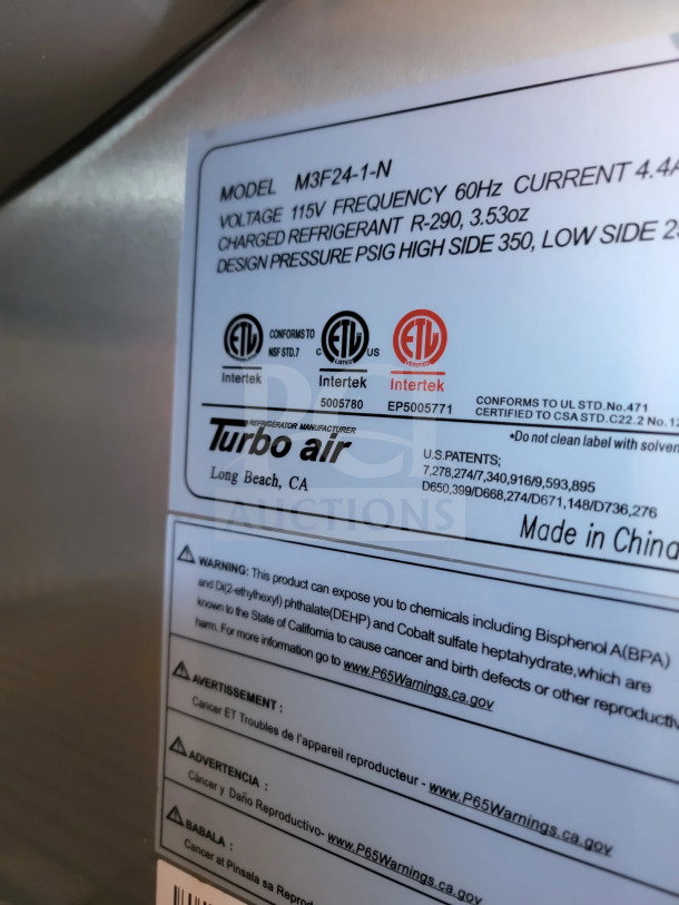 Label on mobile kitchen trailer shows model M3F24-1-N, voltage 115V, frequency 60Hz, refrigerant R-290, and safety warnings.