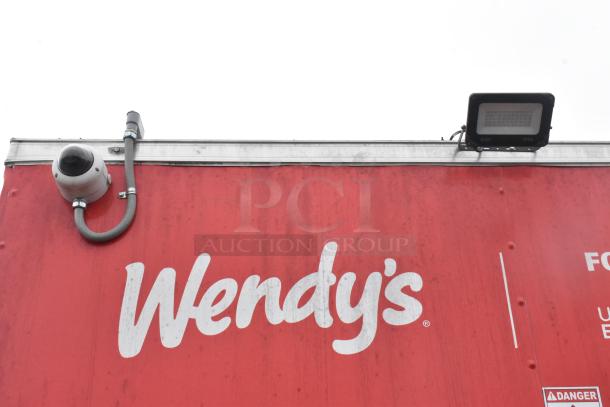 8.5' x 28' Wendy's mobile kitchen trailer, brand new, featuring logos, camera, and light. Fully equipped and ready to use.