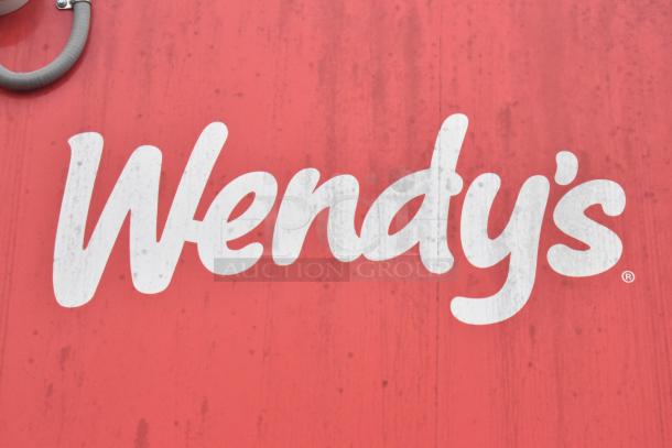 Red Wendy's logo on a mobile kitchen trailer.