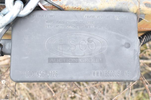 ESCO plastic box with embossed instructions and contact details for inquiries.