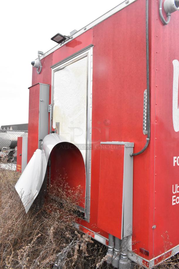 Red 8.5' x 28' Wendy's Mobile Kitchen Trailer with visible plumbing. New, triple axle, sold with clear title.