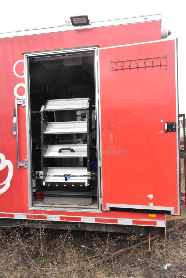 Red Wendy's mobile kitchen trailer featuring adjustable shelving inside, clear title, and fully equipped with tested appliances.