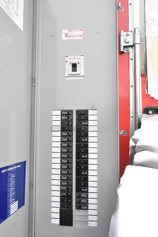 Electrical panel inside a Wendy's mobile kitchen trailer, labeled as 400 AMP 3 PHZ Panel A, with multiple breakers.