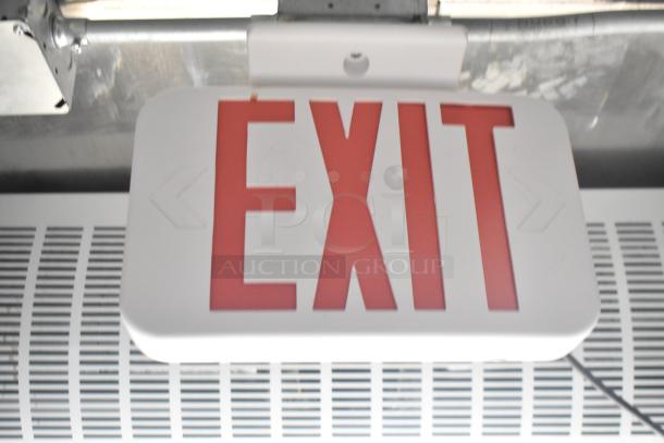 Red and white exit sign in a mobile kitchen trailer.