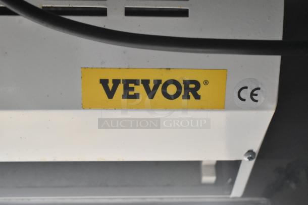 Yellow Vevor label with CE marking on a piece of equipment in a Wendy's mobile kitchen trailer.