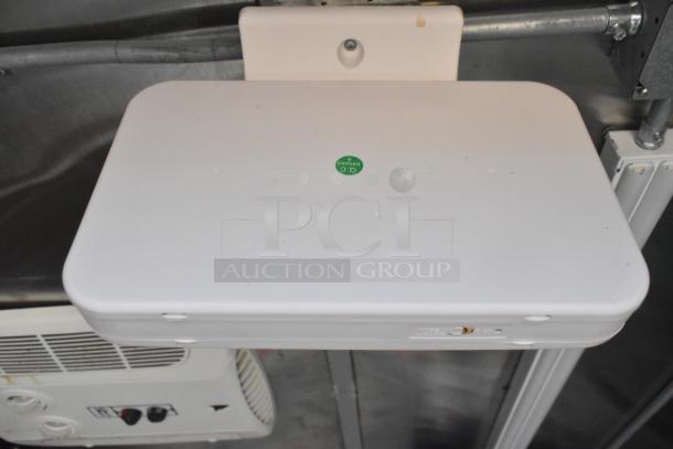 White equipment interior in Wendy's mobile kitchen trailer, showing wiring and a green "QC Passed" sticker.