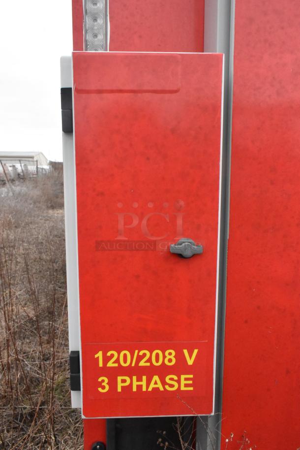 Red mobile kitchen trailer panel with a "120/208 V 3 Phase" label in yellow.