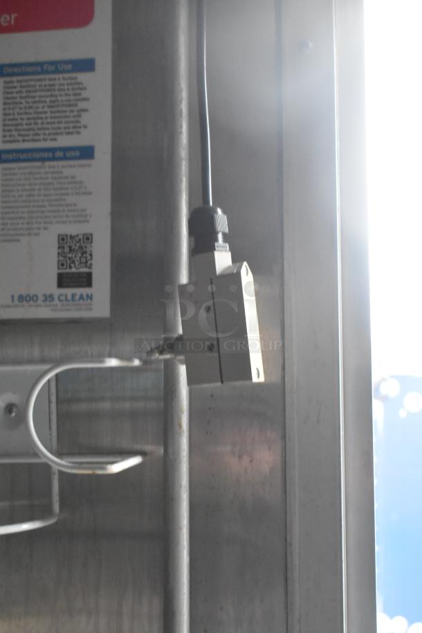 Industrial equipment inside Wendy's mobile kitchen trailer; includes visible instructions and part of wall-mounted device.