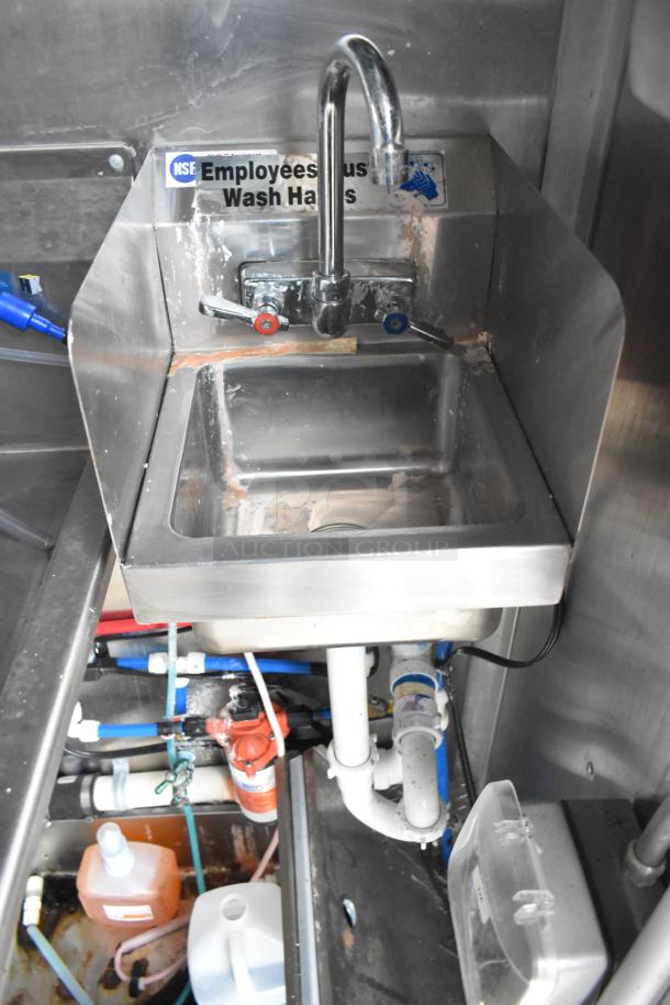 Stainless steel handwashing sink with "Employees must wash hands" NSF sign; includes plumbing fixtures.