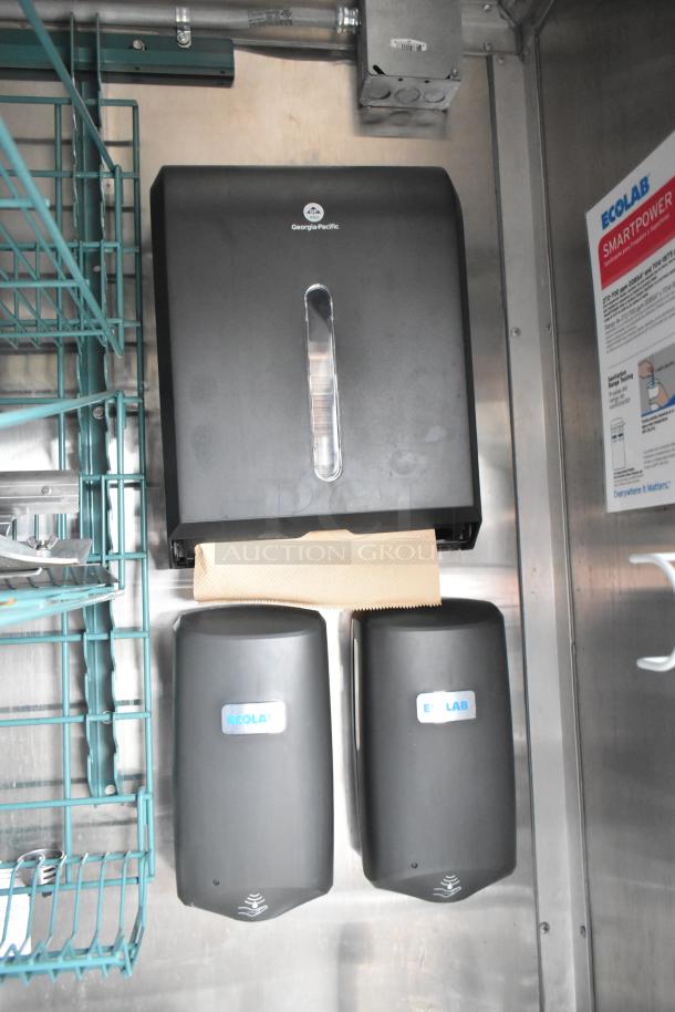 Georgia-Pacific paper towel dispenser and two Ecolab soap dispensers in a stainless steel mobile kitchen setting.