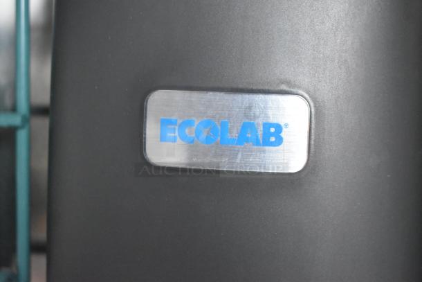 Ecolab label on black surface, indicating the brand. Part of the Wendy's Mobile Kitchen auction item.