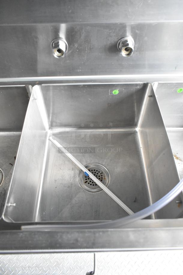 Stainless steel sink in a fully equipped mobile kitchen trailer, brand new and unused.