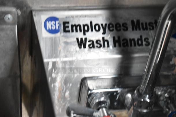 "NSF Employees Must Wash Hands" sign above a sink in the mobile kitchen trailer.