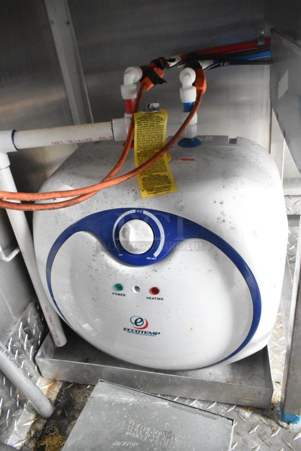 Ecotemp tankless water heater in Wendy's mobile kitchen trailer, power and heating indicators visible.