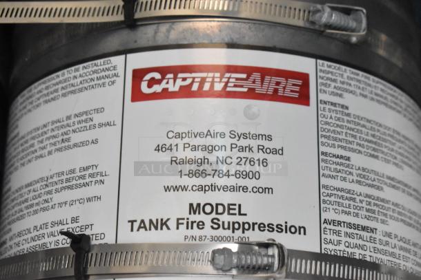 CaptiveAire Tank Fire Suppression label with model and contact information, part of mobile kitchen trailer equipment.