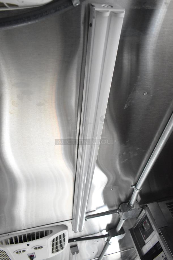 Interior ceiling of brand new 8.5' x 28' Wendy's Mobile Kitchen Trailer with wiring and ventilation systems visible.