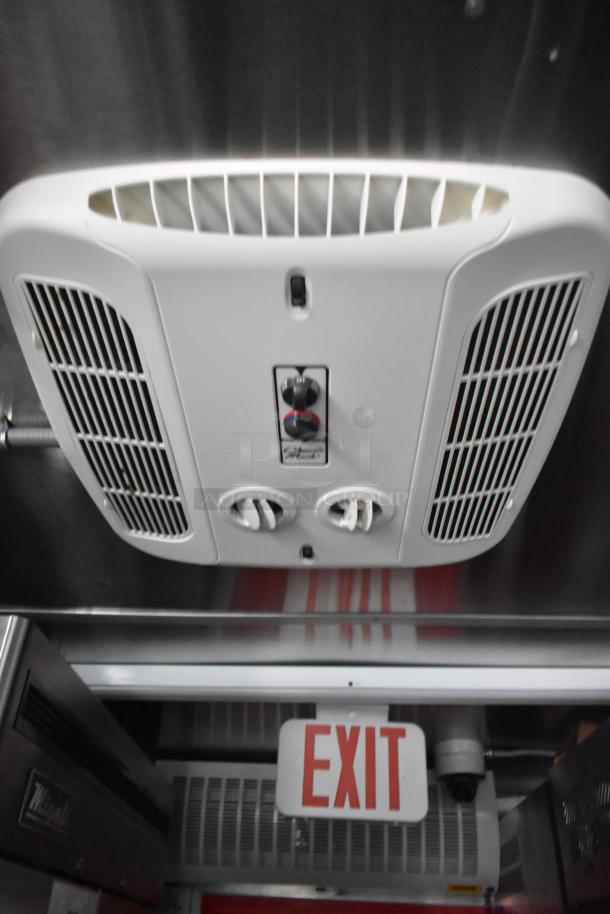 Wendy's mobile kitchen trailer interior with Coleman Mach A/C, Metro C5 cabinet, and EXIT sign.