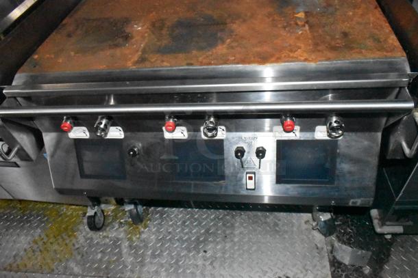 Wendy's mobile kitchen trailer with Garland clamshell grill, stainless steel, triple axle, full plumbing, tested equipment.