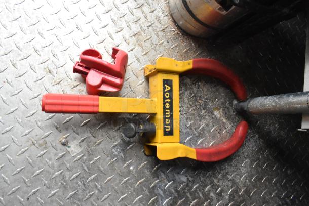 Aoteman wheel lock clamp on a textured metal floor.