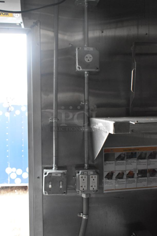 Interior view of brand new Wendy's mobile kitchen trailer showing outlets, wiring, and part of a grease hood.