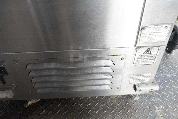 Close-up of a stainless steel panel with H&K International labels detailing safety warnings for propane use.