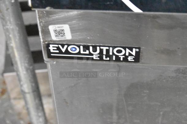 Henny Penny Evolution Elite label on a metal surface of the mobile kitchen trailer, indicating included equipment.