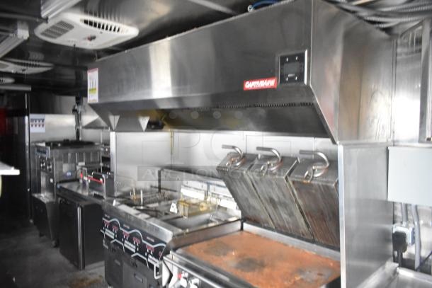 Brand new 8.5' x 28' Wendy's mobile kitchen trailer with Henny Penny fryer, Taylor ice cream, Garland grill, CaptiveAire hood.