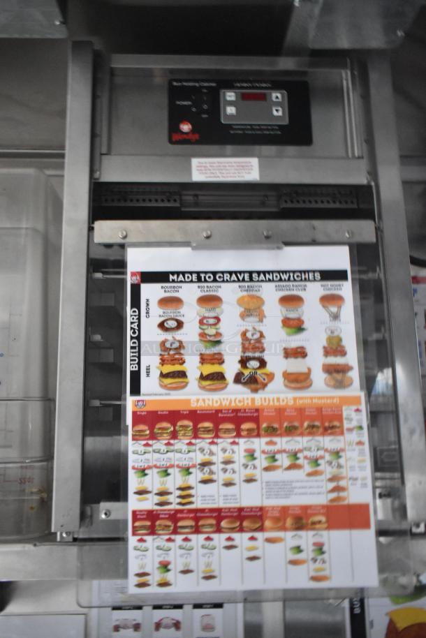 Brand new Wendy's mobile kitchen trailer interior, featuring a Henny Penny holding cabinet and sandwich build guide.