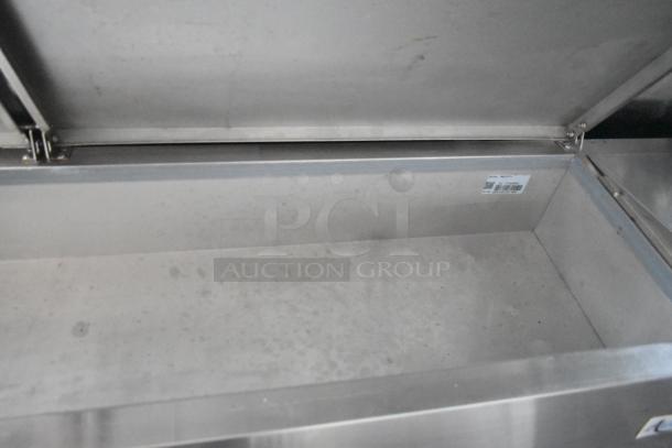 Interior view of a new stainless steel compartment in a Wendy's mobile kitchen trailer. Clean and unused.