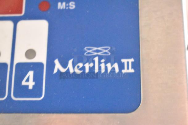 Close-up of a Merlin II control panel with buttons and markings, part of a mobile kitchen trailer equipment.