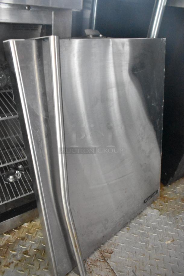 Stainless steel component inside a Wendy's Mobile Kitchen Trailer, featuring diamond-patterned steel flooring and shelving.