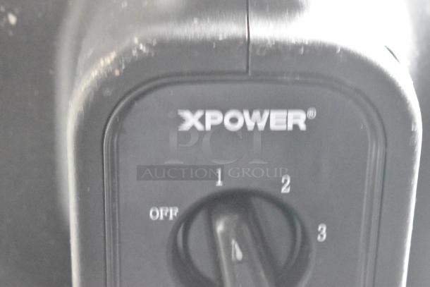 Alt text: Close-up of XPOWER device with dial showing settings from off to 3.