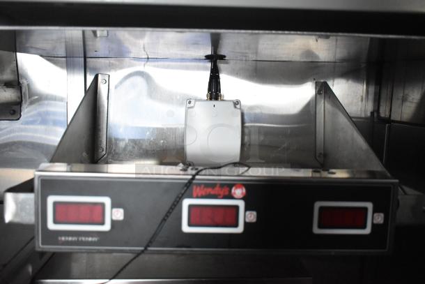 Brand new Wendy's mobile kitchen trailer with Henny Penny fryer, shown with Wendy's branded control panel, stainless steel interior.