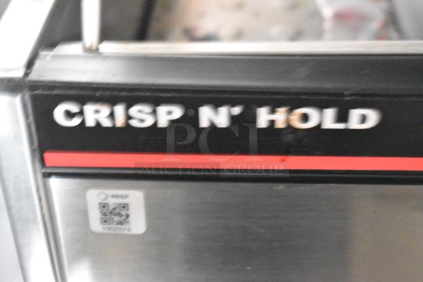 "Crisp N' Hold" sign on metal kitchen equipment with QR code and serial number 1026974.