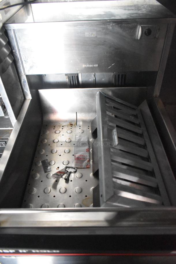 Interior of Wendy's mobile kitchen trailer with metal components and accessories. Clean, well-maintained condition.