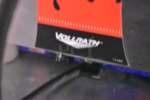 Close-up image of a red and black Vollrath label on equipment in a Wendy's mobile kitchen trailer.