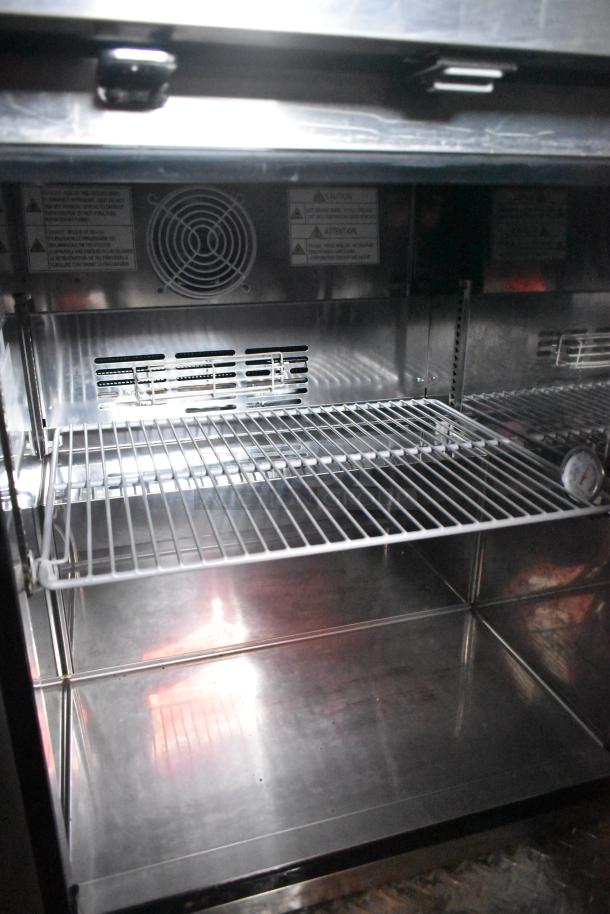 Interior of Wendy's mobile kitchen trailer showing a clean, empty metal rack and fan vent, indicating brand new condition.