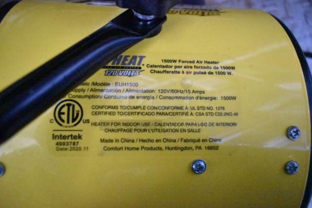 Yellow Comfort Zone heater label showing model EUH1500, 1500W power, 120V/60Hz/15A, certified for indoor use, made in China.