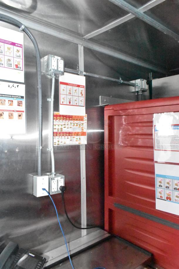 BRAND NEW 8.5' x 28' Wendy's Mobile Kitchen Trailer with instruction posters visible on stainless steel interior.